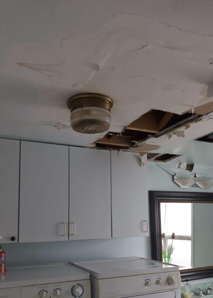 bathroom with hole in ceiling due to water damage